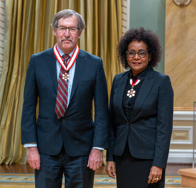 John J. Clague is standing next to The Right Honourable Michaëlle Jean.