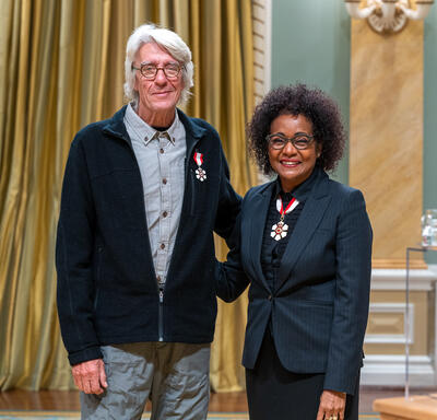  Christian Barthomeuf is standing next to The Right Honourable Michaëlle Jean.