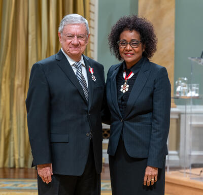 Izak Benbasat is standing next to The Right Honourable Michaëlle Jean.