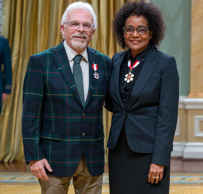 Alain Chartrand is standing next to The Right Honourable Michaëlle Jean.