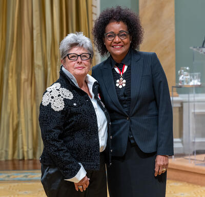 Hana Gartner is standing next to The Right Honourable Michaëlle Jean.