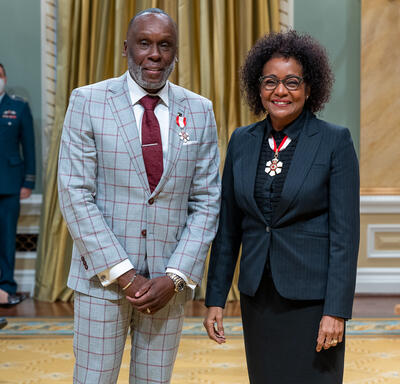 Bruny Surin is standing next to The Right Honourable Michaëlle Jean.