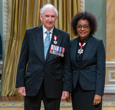 Gordon W. Walker is standing next to The Right Honourable Michaëlle Jean.