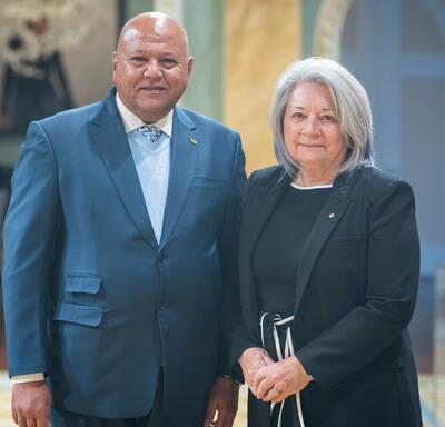 Governor General Simon is standing next to His Excellency Purmanund Jhugroo.