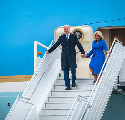 President Joe Biden and First Lady Jill Biden exit the airplane and walk down stairs.
