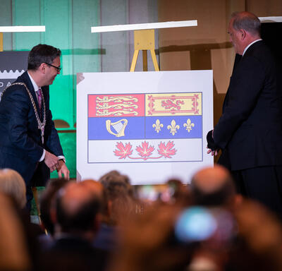 Dr. Samy Khalid unveils Canadian flag of His Majesty