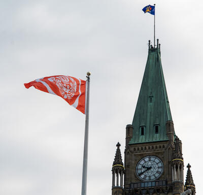 An Every Child Matters flag flies near the Peace Tower