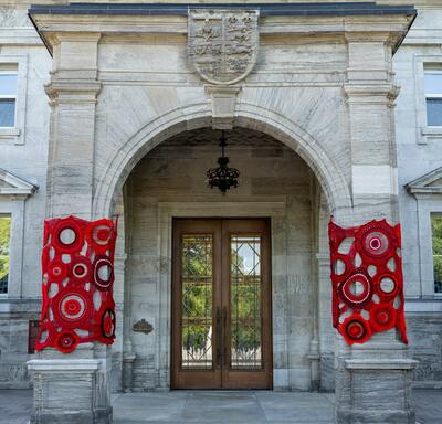 Crochet art by Métis artist Tracey-Mae Chambers hangs on the porte-cochère of Rideau Hall