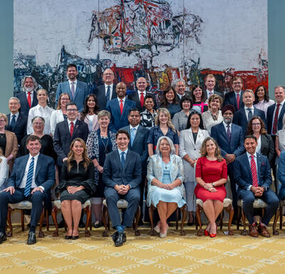 Governor General Marie Simon sits with Prime Minister Justin Trudeau and new Ministers for a group photo in the Rideau Hall Ballroom