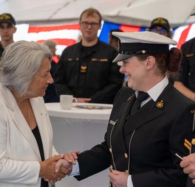 Governor General Mary Simon shakes hands with a member of the Royal Canadian Navy.