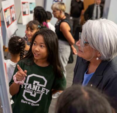 Governor General Mary Simon looks at projects with one of the students.