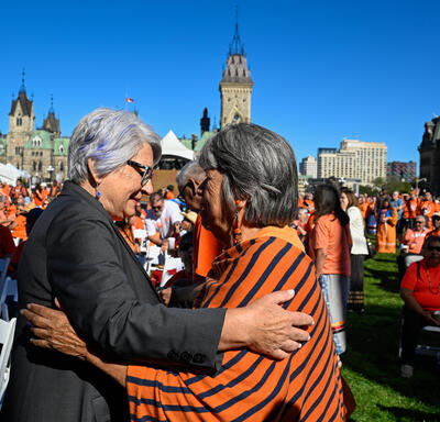 Governor General Mary Simon greeting a person outside of Parliament Hill at an event for National Day for Truth and Reconciliation.
