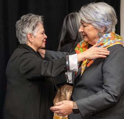 Governor General Mary Simon and a woman embracing.