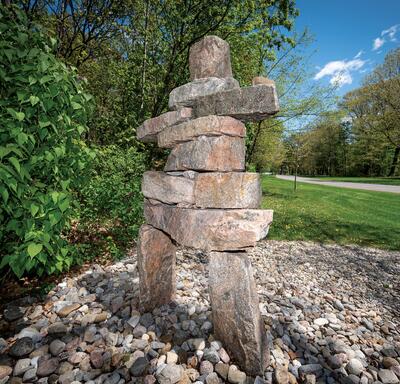 A close-up of an inuksuk made of piled stones.