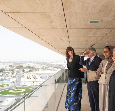 Governor General Mary Simon, Mr. Whit Fraser, Her Excellency Sheikha Hind bint Hamad Al Thani and a woman stand on a balcony. 