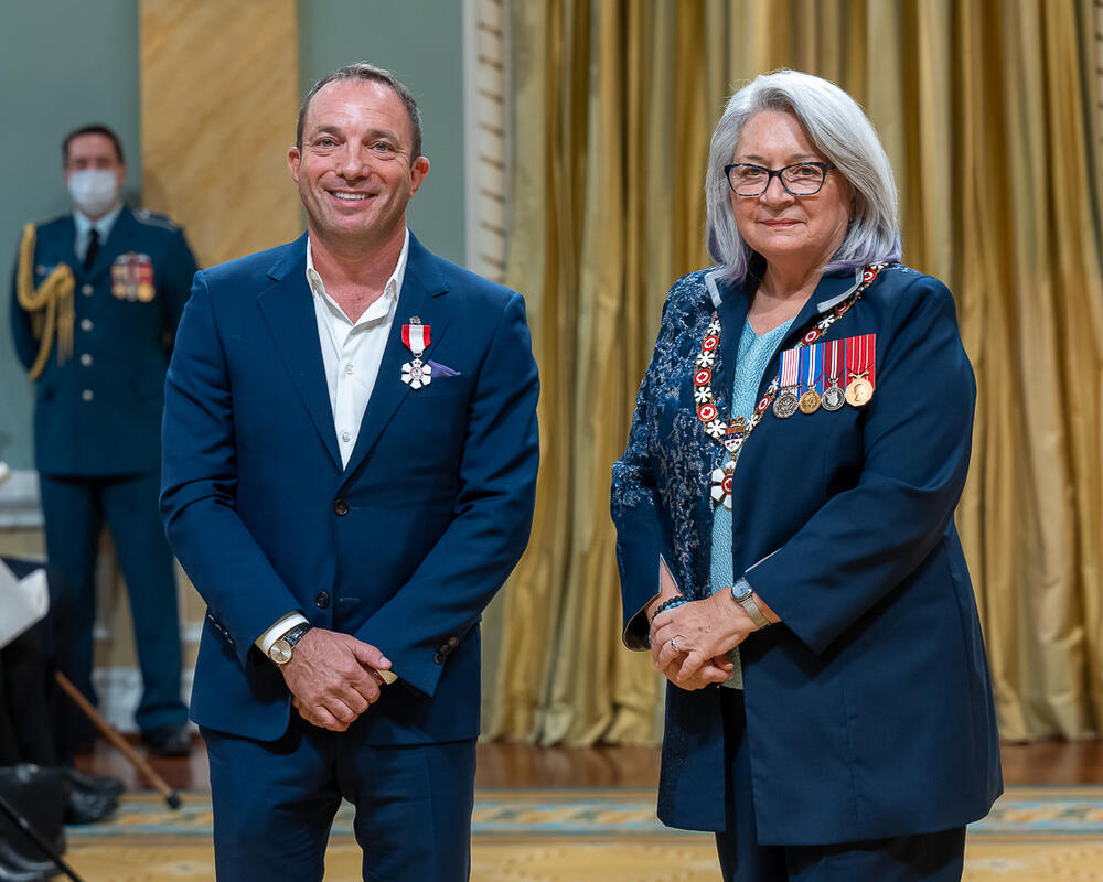 Mitch Garber is standing next to the Governor General.