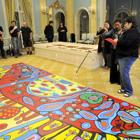 Installation of a Norval Morrisseau painting in the Rideau Hall Ballroom