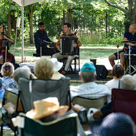 The Ladom Ensemble quartet performs on the grounds of Rideau Hall, under a tent, for Chamberfest.