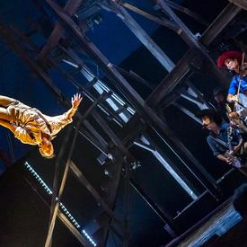 Two people perform acrobatics. 