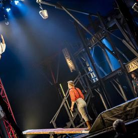 Two people perform acrobatics. 