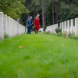 The Governor General looks intently at tombstones at the Bergen-op-Zoom Canadian War Cemetery.
