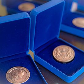 Three Governor General's Academic All-Canadian Commendation medal displayed in opened blue boxes on a table.
