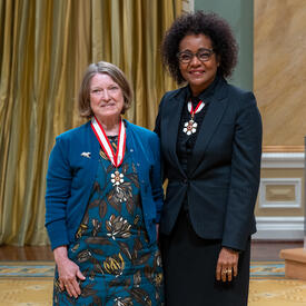 Debra Pepler is standing next to The Right Honourable Michaëlle Jean.