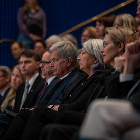 Governor General Simon sitting in an audience. Sauli Niinistö, President of the Republic of Finland, is seated next to her.