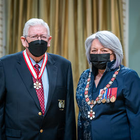 Eldon C. Godfrey is standing next to the Governor General.