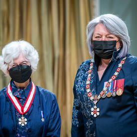 Noni MacDonald is standing next to the Governor General.