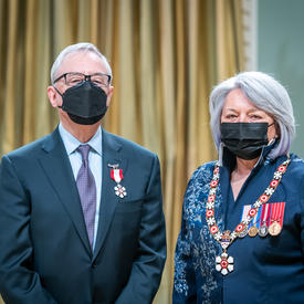 Derek Lister is standing next to the Governor General.