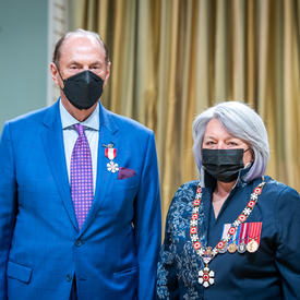 James W. Treliving is standing next to the Governor General.