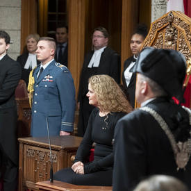 The Governor General sits in the Senate Chamber.