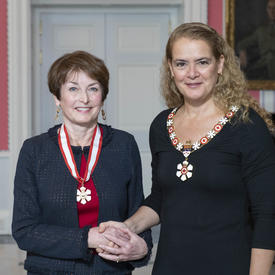 Governor General, Julie Payette, stands next to Elizabeth Eisenhauer. Both wear their Order of Canada insignias. 