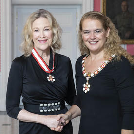 The Governor General, Julie Payette, stands next to Catherine O'Hara.  Both are wearing their Order of Canada insignias.
