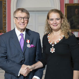 The Governor General, Julie Payette, stands next to Allan Andrews.  Both are wearing their Order of Canada insignias.