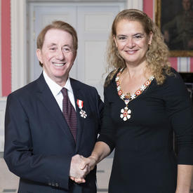 The Governor General, Julie Payette, stands next to Mark Breslin.  Both are wearing their Order of Canada insignias.