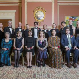 A group photo of all sixteen winners of the 2018 Governor General’s Literary Awards with Governor General Julie Payette and Simon Brault.  The front row is seated, the back row is standing.  