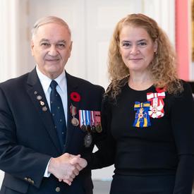 The Governor General stands next to recipient Pierre Cécil who is wearing the Sovereign’s Medal for Volunteers he has just received. 