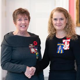 The Governor General stands next to recipient Sara Charron who is wearing the Sovereign’s Medal for Volunteers he has just received. 