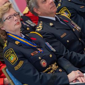 Recipients of the Order of Merit of the Police Forces sit in the front row during the investiture ceremony.