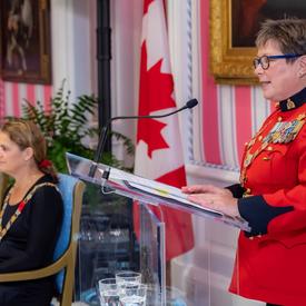 Brenda Lucki, Commissioner of the RCMP, delivers remarks at a podium during an Order of Merit of the Police Forces investiture ceremony.