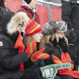 Fans bundled for the cold sit in the stands.