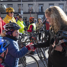 The Governor General shook hands with a cyclist. 