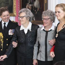  Isabella Rhoda Wurtele Eaves stands center right and her twin sister, Grace Rhona Wurtele Gillis, center left.  They are flanked by the Governor General on the right and a young military officer to the left. 