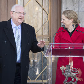 The Governor General delivers remarks from a podium outside and the President of Israel is standing beside her. 