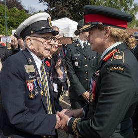 The Governor General shakes hands with a veteran. 