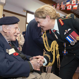 The Governor General shakes hands with a veteran. 