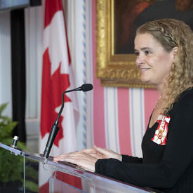 The Governor General delivers opening remarks at a podium.