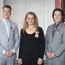 The Governor General stands between Brothers Jeremy (left) and Devon Liscum (right).